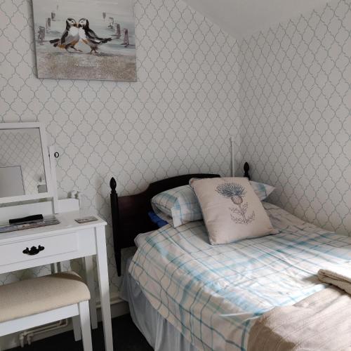 Ένα ή περισσότερα κρεβάτια σε δωμάτιο στο Schofield Guest House