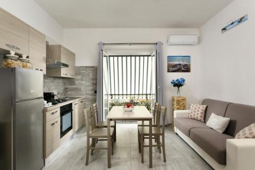 a kitchen and living room with a table and a couch at APPARTAMENTO OSIDE HOUSE alloggio turistico in Trevignano Romano