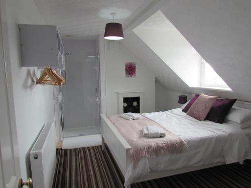 Ένα ή περισσότερα κρεβάτια σε δωμάτιο στο The Loft Apartment
