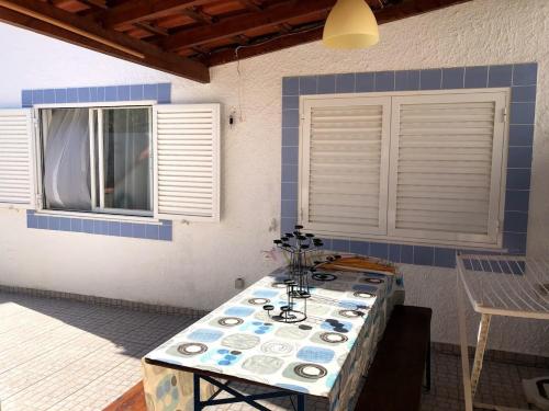 a room with a table with plates on it at Apartamento Limões in Carvoeiro