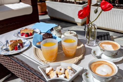 a table topped with plates of food and cups of coffee at Angiolina's Farm in Levanto