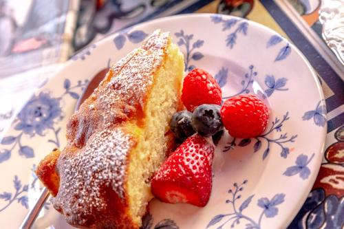 a piece of cake on a plate with strawberries at Angiolina's Farm in Levanto