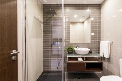 a bathroom with a glass shower and a sink at ALBUFEIRA (OLD TOWN) VERASOL AA - THE LUXURY STAY in Albufeira
