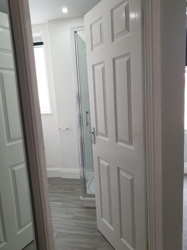a white door in a room with a mirror at No 27 Chapel Street Guest House in Llandudno