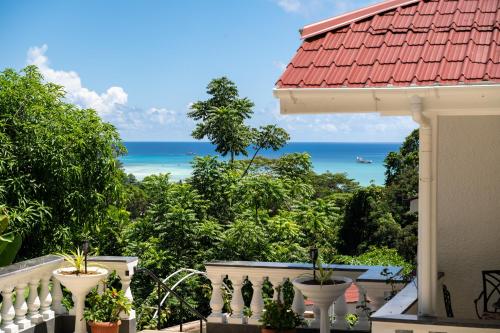 a balcony with a view of the ocean at Janes' Serenity Guesthouse in Anse a La Mouche
