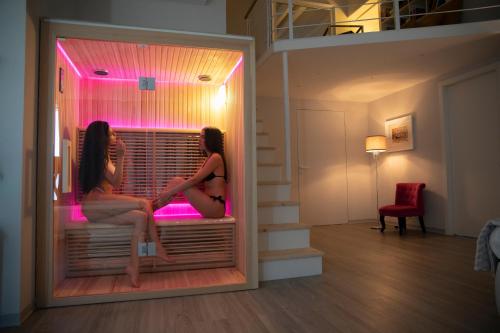 two girls sitting on a bed in a room at Bellavista B&B di Charme in Macchiagodena