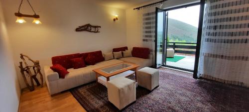 ein Wohnzimmer mit einem Sofa und einem Tisch in der Unterkunft PURE NATURE in Visoko