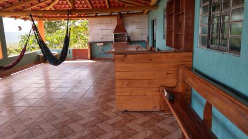 a porch of a house with a hammock in it at Recanto Malop in Três Marias