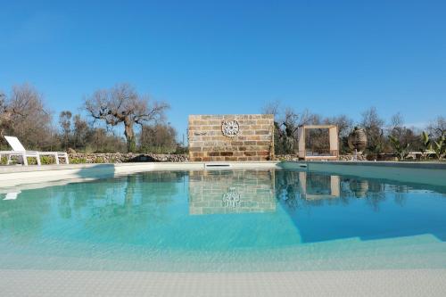 a large swimming pool with a building in the background at Tenuta Cesarina in Alessano