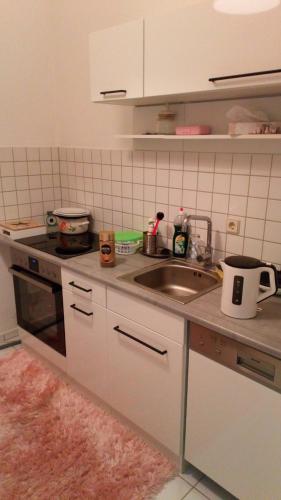 a kitchen with a sink and a counter top at Wohnung "Stern" in Chemnitz