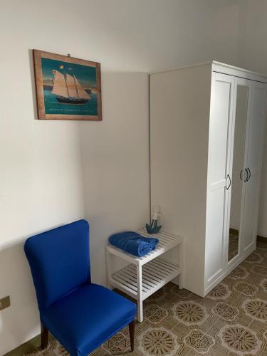 a blue chair and a table in a room at TENUTA TAURIANUM PanoramicHouse e PanoramicB&B in Palmi