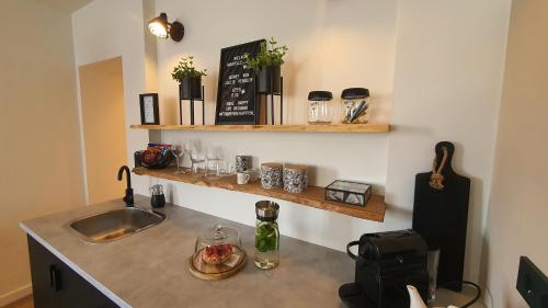 a kitchen with a sink and a counter top with a counter top at B&Be Happy in Berg en Terblijt