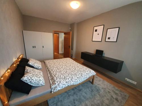 a bedroom with a large bed and a room with at Apartman Moderna Donovaly in Donovaly