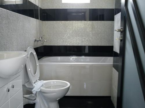 a bathroom with a toilet and a tub and a sink at Villa Princess Maria in Balchik