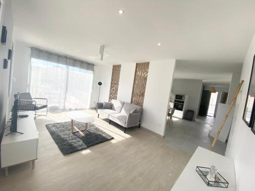 a living room with a couch and a table at Belle maison de 140m2, proche centre ville in Challans