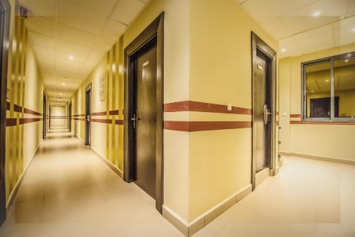 a corridor of an office building with doors at AKWA HIN Douala in Douala