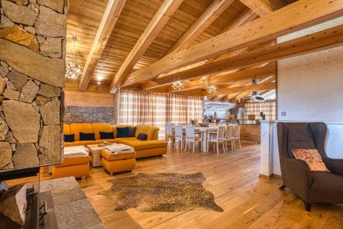 a large living room with a couch and a table at Chalet SNOW in Demanovska Dolina