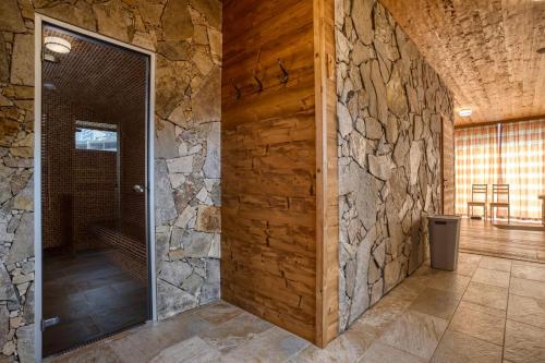 a stone wall in a hallway with a door at Chalet SNOW in Demanovska Dolina