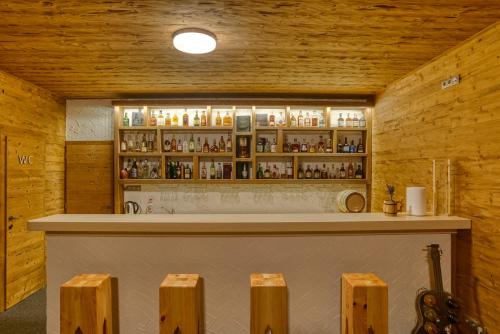 a bar in a room with wooden walls at Chalet SNOW in Demanovska Dolina