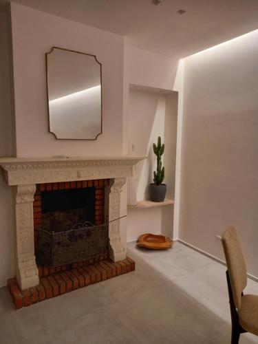 a living room with a fireplace and a mirror at Dimora50 Apartament in Porto Recanati