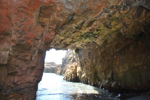 a cave in the side of a cliff at Lodge Casa Vieja in Curanipe