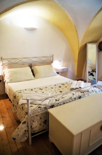 a bedroom with a bed with a yellow ceiling at Morgana in Casarano