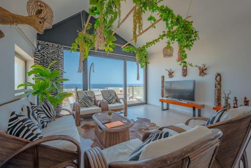 VESTA - Soma Bay Residence في الغردقة: غرفة معيشة مع كراسي وتلفزيون بشاشة مسطحة