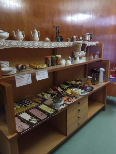 Eine Vitrine mit einem Haufen Essen drauf. in der Unterkunft Hotel Cervantes in Curitiba