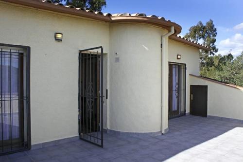 a house with two gates on the side of it at Villadora in Santa Coloma de Farners