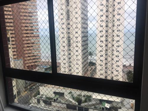 a window with a view of a building at Lindo Ap 1102 Vista do Mar c Garagem in Recife