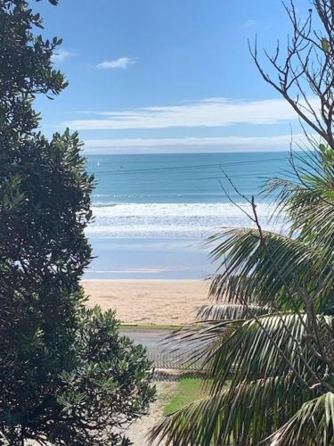 a view of a beach with the ocean at Oneroa Bay Villa Waiheke in Oneroa