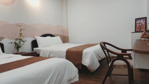 Giường trong phòng chung tại Emmie Nha Trang Hotel