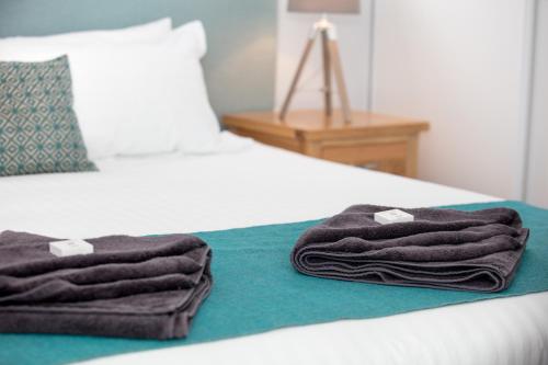 
a bed with a blanket on top of it at Jurien Bay Motel Apartments in Jurien Bay
