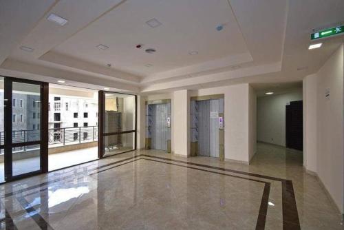 a large empty room with a view of a building at City Central Apartment in Yerevan