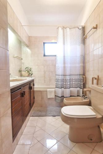 a bathroom with a toilet and a sink at Rustic Beach House at the Cliff T3 | C218 in Porches