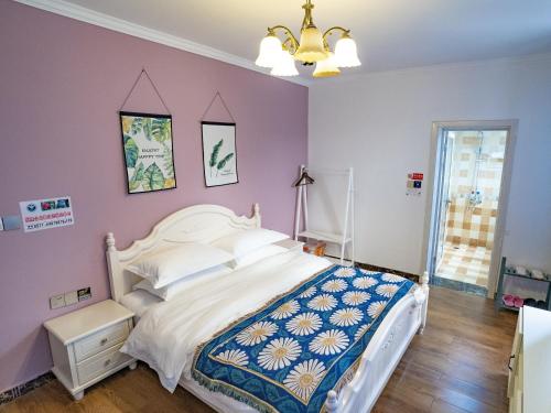 a bedroom with a white bed and purple walls at A Ben Min Su in Thousand Island Lake