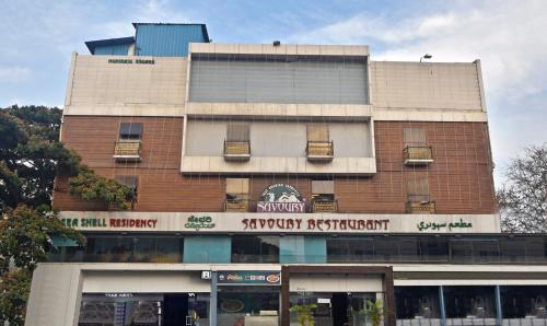 a building with a sign on the front of it at Treebo Savoury Sea Shell Residency in Bangalore