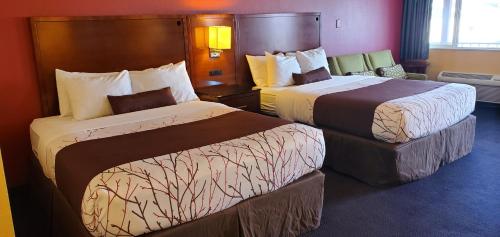 a hotel room with two beds in a room at Olympic Inn & Suites in Aberdeen