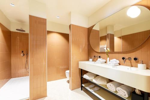a bathroom with a sink and a mirror at Hotel Grand Koper in Koper