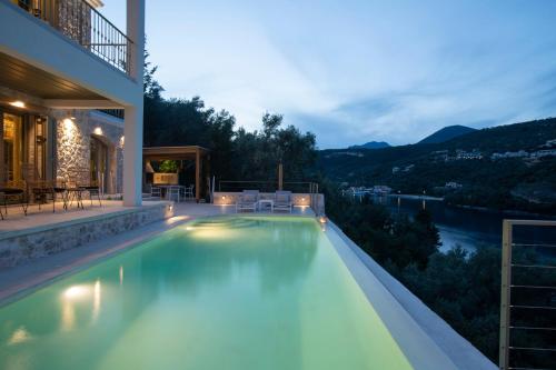a swimming pool in a house with a view at Villa Anthelia-Idyllic view and private access to the sea in Sivota