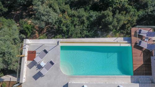 an overhead view of a swimming pool on top of a house at Villa Anthelia-Idyllic view and private access to the sea in Sivota
