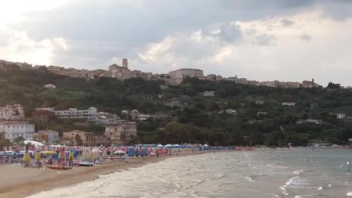 a beach with a bunch of umbrellas and the ocean at Villa San Giacomo in Scerni