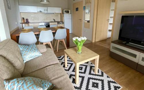a living room with a couch and a table at Panoráma Apartmanház in Balatonfüred