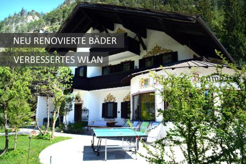 una casa con un tavolo blu davanti di Pension Almhof Baumgarten a Bad Reichenhall