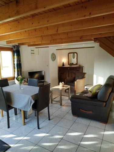 a living room with a couch and a table at Ti Bihan - Meublé in Santec
