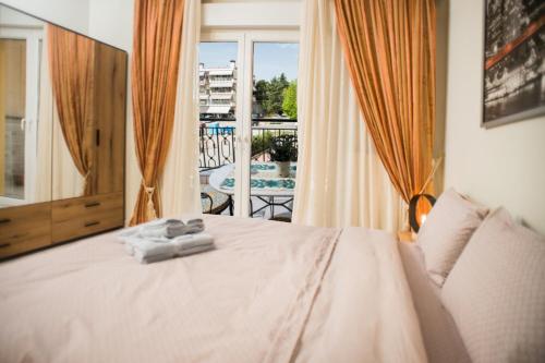 a bedroom with a bed and a view of a pool at Comfort Studio in Thessaloniki