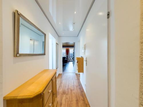 a hallway with a wooden table and a mirror on the wall at Chalet Alpenglühen in Garmisch-Partenkirchen