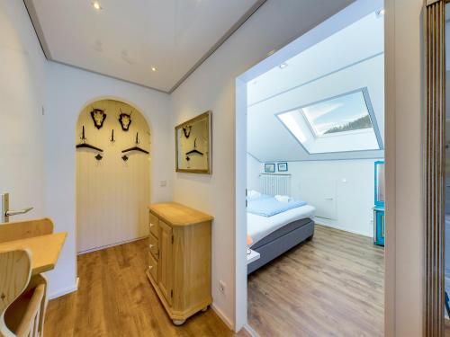 a bedroom with a bed and a desk and a window at Chalet Alpenglühen in Garmisch-Partenkirchen
