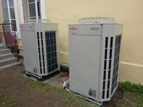 two electrical boxes sitting outside of a building at Cit'Hotel de La Vallée in Lourdes