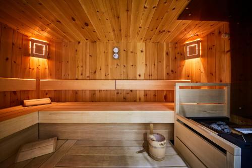 a wooden sauna with a bench in it at Fuchs und Gretl in Saalbach Hinterglemm